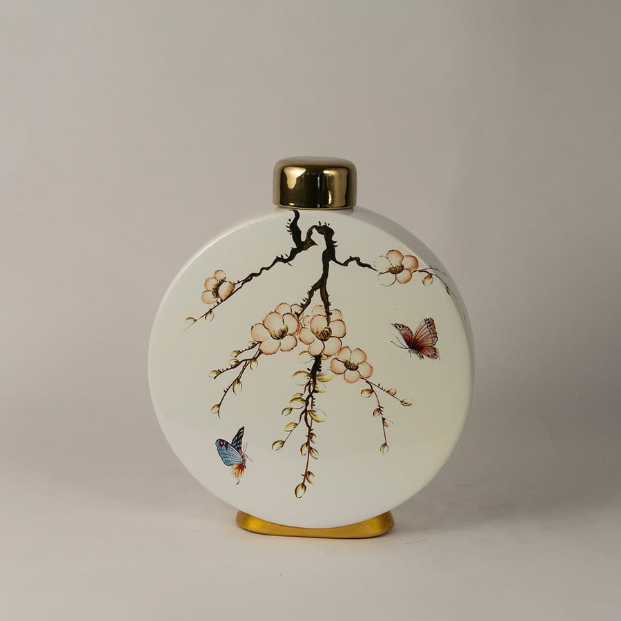 Round ceramic jar featuring hand-painted cherry blossoms and butterflies with gold detailing on lid and base.