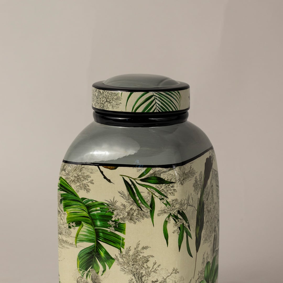 Closeup of tropical leaf jar showing intricate hand painted leaf patterns and smooth finish.