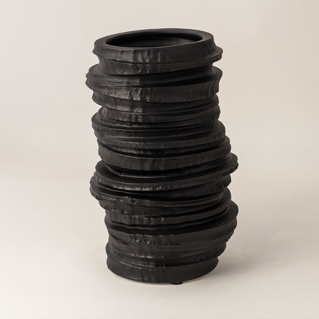 Aero black ceramic vase displayed on a white background showcasing its handcrafted stacked texture and matte finish for modern home styling.