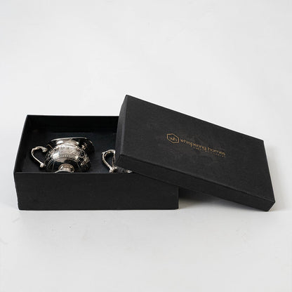 Ornate silver sugar and creamer set placed in a black gift box with lid open for premium packaging presentation.