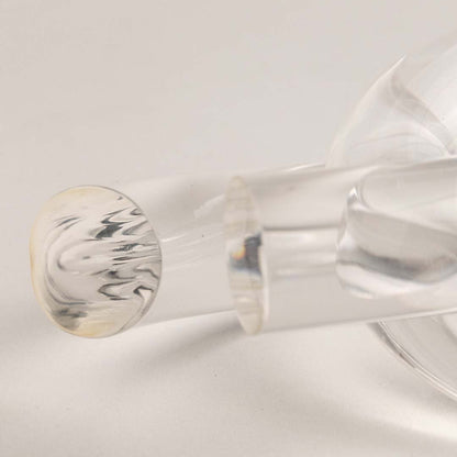 Closeup of clear glass decorative sculpture with rounded form highlighting refined craftsmanship and artistic detailing.
