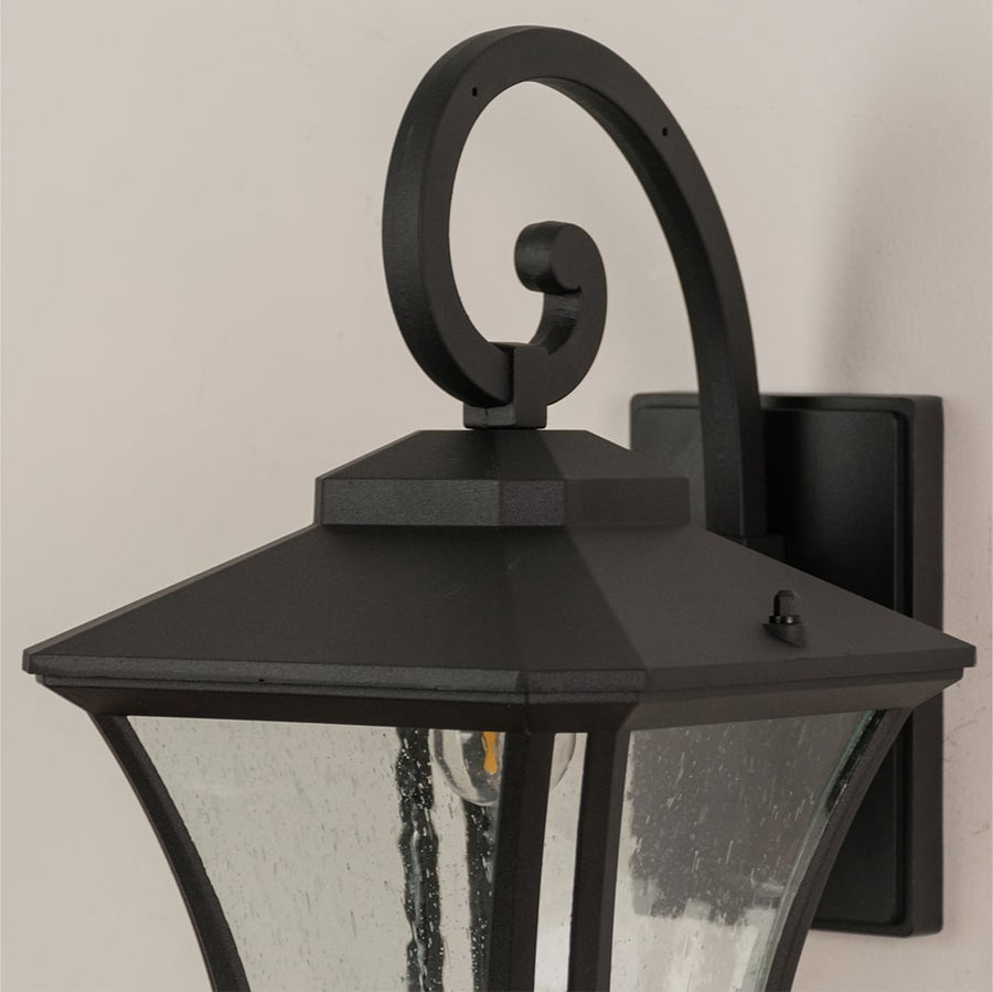 Detailed view of black outdoor lantern showcasing clear textured glass and sturdy metal frame for exterior lighting.