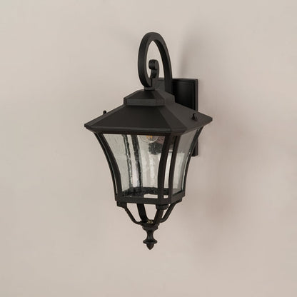 Black metal outdoor wall lantern with clear textured glass shown off to highlight design for exterior home settings.