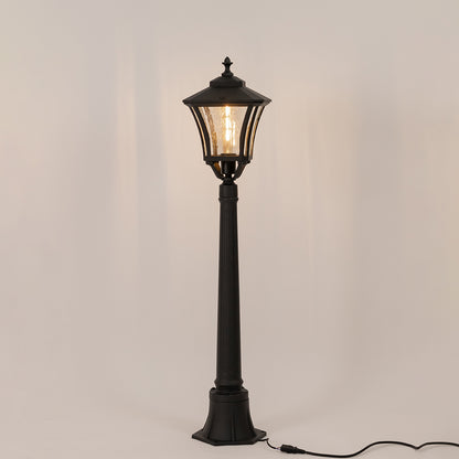Vintage black outdoor garden light with warm glowing bulb for elegant exterior decor styling use.