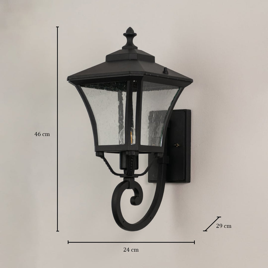 Black metal outdoor wall lantern with textured glass measuring 46 cm height 24 cm width and 29 cm depth for exterior use.