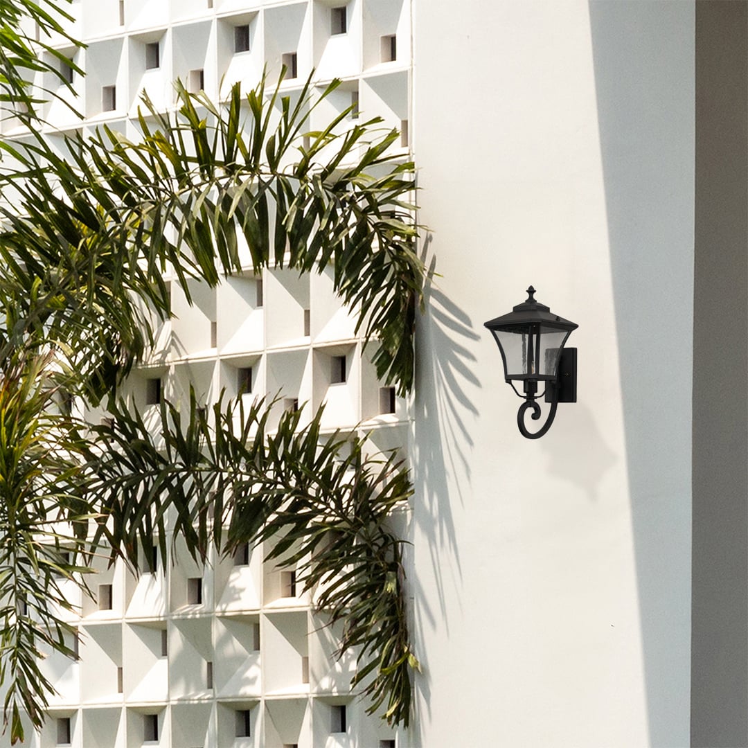 Stylish black outdoor wall lantern adds warm ambience to home exteriors perfect for porch garden and balcony lighting.