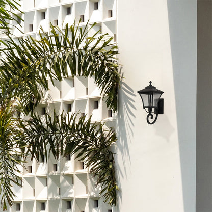 Stylish black outdoor wall lantern adds warm ambience to home exteriors perfect for porch garden and balcony lighting.
