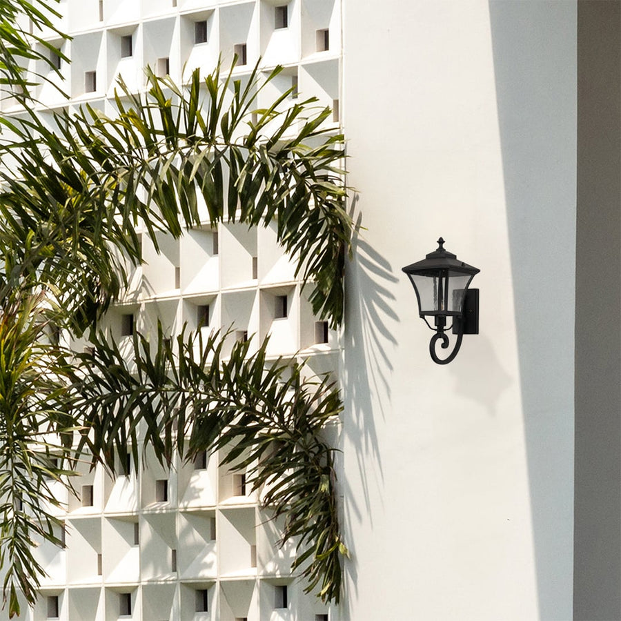 Stylish black outdoor wall lantern adds warm ambience to home exteriors perfect for porch garden and balcony lighting.