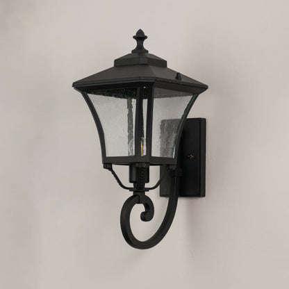 Black metal outdoor lantern with textured glass shown unlit highlighting durable build for entryway and porch walls.
