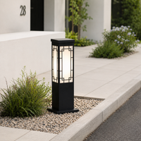 Modern craftsman black metal bollard pillar light for home villa driveway walkway gravel pathway and exterior garden styling.