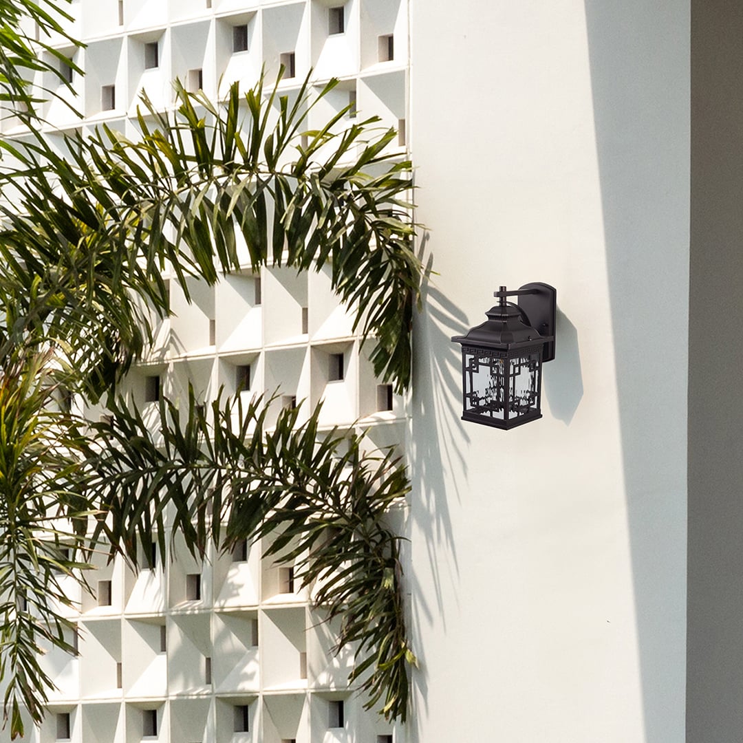 Outdoor wall light mounted on exterior wall near greenery providing warm illumination and enhancing modern facade and balcony decor.