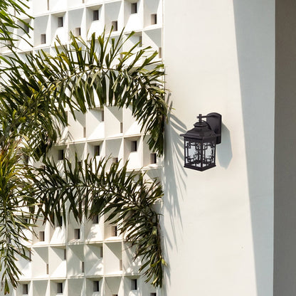 Outdoor wall light mounted on exterior wall near greenery providing warm illumination and enhancing modern facade and balcony decor.