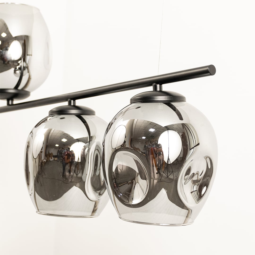 Close view of chrome glass globes chandelier showing glossy metallic finish black metal rod and detailed modern craftsmanship quality.