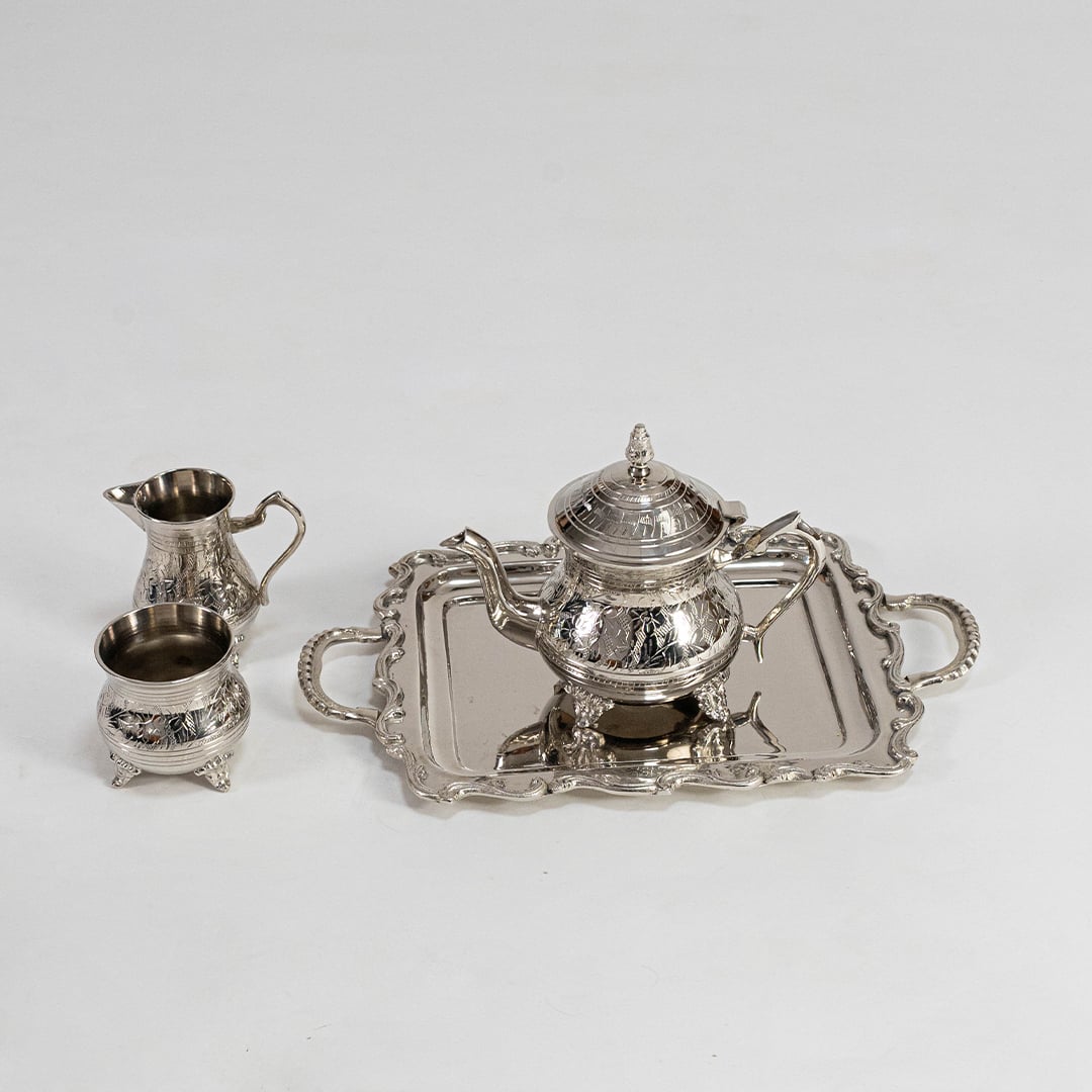 Silver tea set arranged securely in premium black box with foam inserts perfect for luxury gifting and protection.