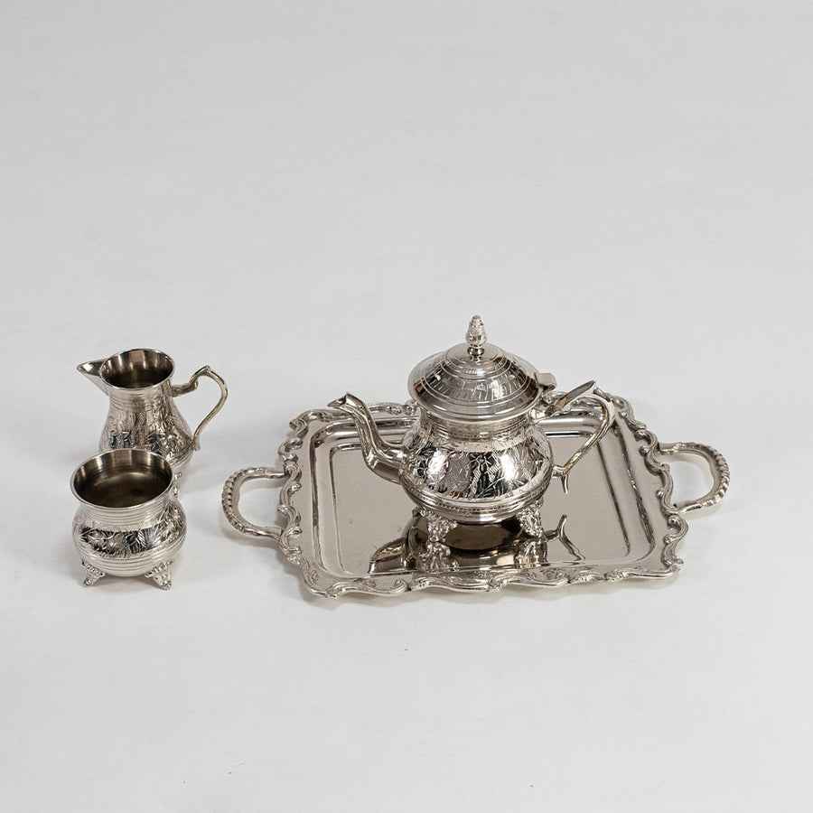 Silver tea set arranged securely in premium black box with foam inserts perfect for luxury gifting and protection.