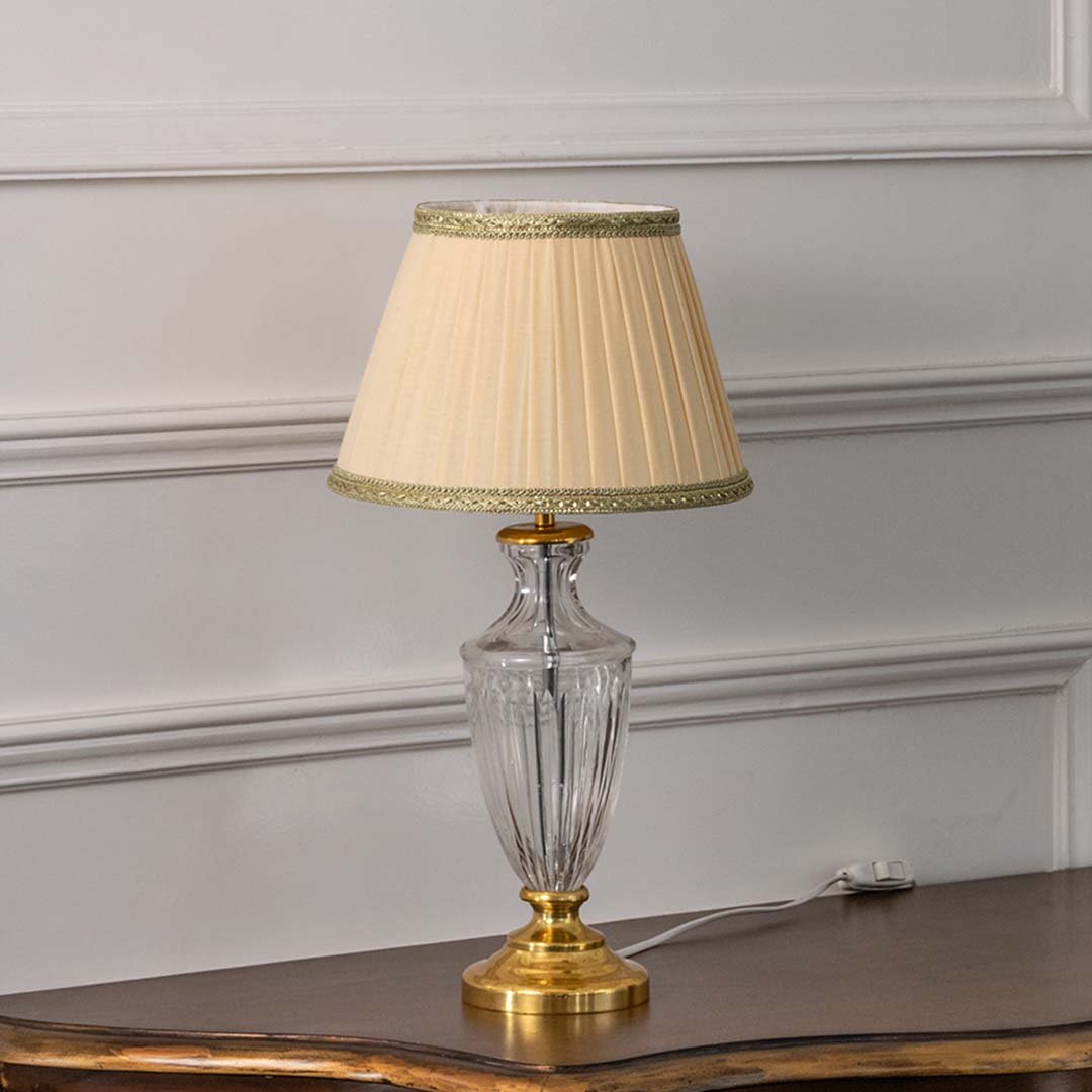 Clear etched glass table lamp with pleated fabric shade and brass accents designed for elegant traditional table lighting.