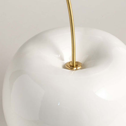 Closeup of white ceramic decorative vase with gold metal stem highlighting premium craftsmanship and elegant styling.
