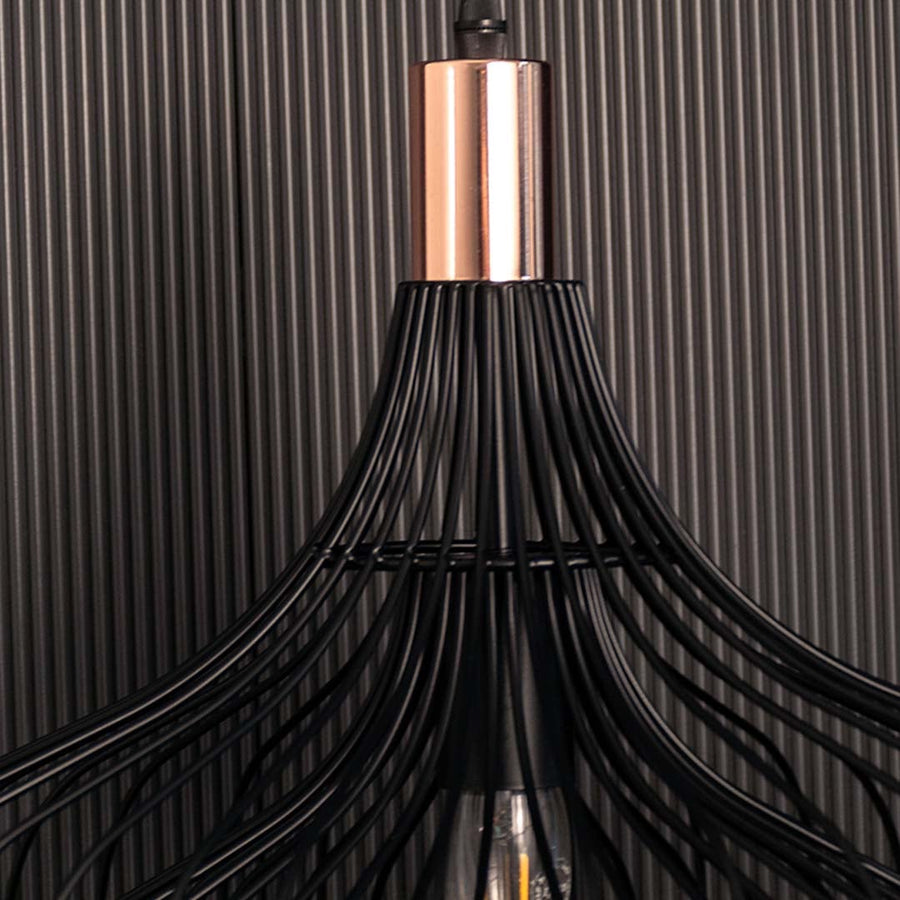 Closeup of the black wire pendant lamp showing the metal road and visible bulb for an artistic modern look.