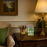 White ceramic jar with gold and green tiger design adding a luxurious accent to a classic wooden side table.