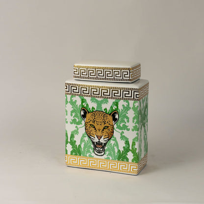 Side angle view of white ceramic jar showing gold-trimmed edges and detailed hand-painted leopard artwork.
