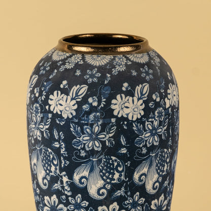 Artistic ceramic vase in deep blue with white hand painted floral motifs and golden rim finish for timeless decor.