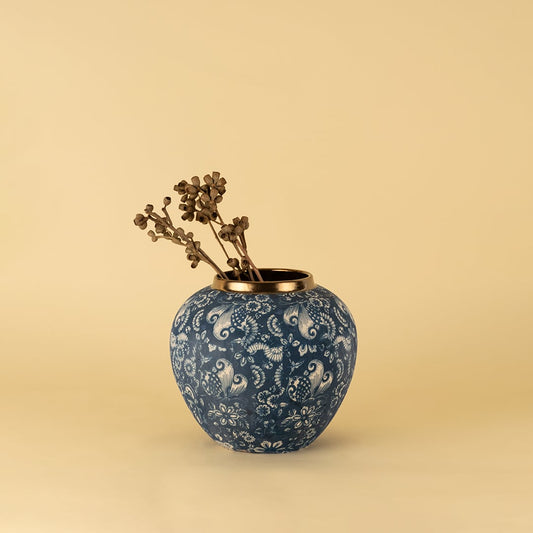 Blue ceramic vase with golden rim in floral paisley pattern styled as decorative accent for elegant modern home interiors.