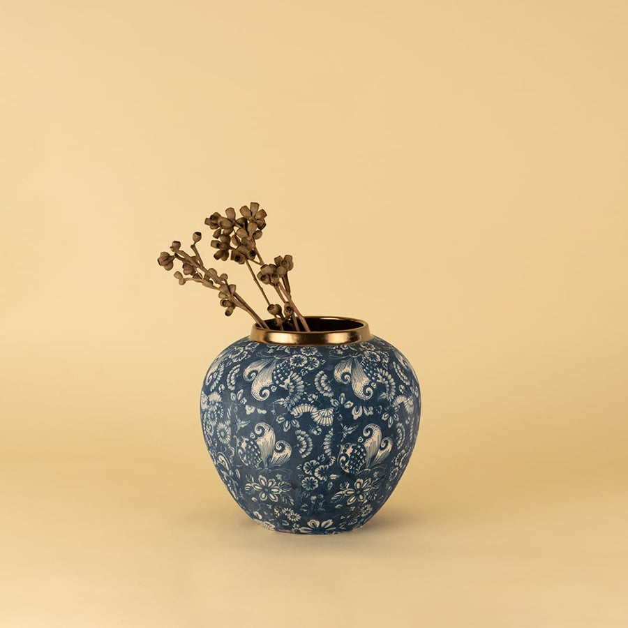 Blue ceramic vase with golden rim in floral paisley pattern styled as decorative accent for elegant modern home interiors.