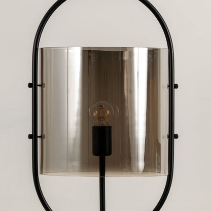 Closeup view showing the smooth smoked chrome glass surface and fine metal craftsmanship with a visible filament bulb detail.