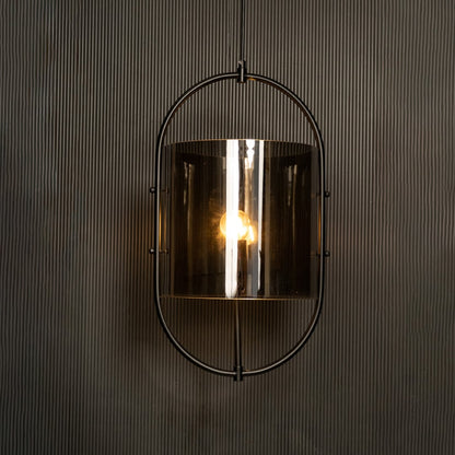 Illuminated pendant showcasing a striking contrast between the black metal frame and smoked glass against a dark backdrop.