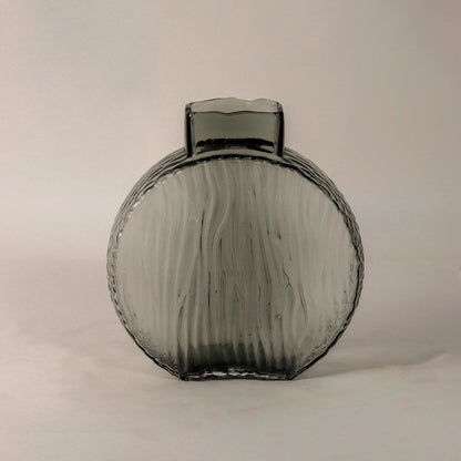 Elegant smoky gray decorative glass vase with round ribbed body and artistic wavy texture shown on white backdrop.