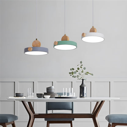 Wood and metal pendant light set in grey green and white styled above dining table for modern home interior lighting.