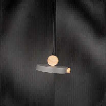 Wood and metal pendant light bulb off on black background with circular round design for modern interior lighting.