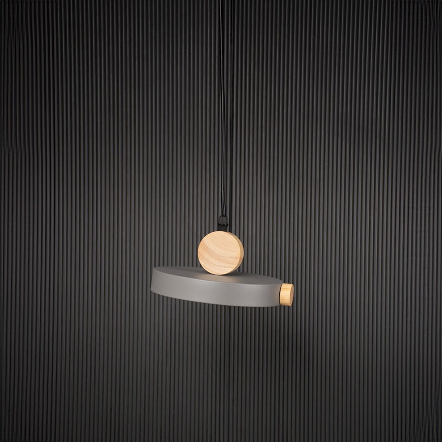 Wood and metal pendant light bulb off on black background with circular round design for modern interior lighting.