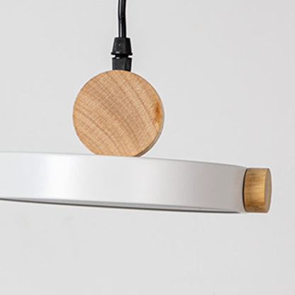 Closeup of modern pendant light with flat round metal shade and natural wood detail designed for stylish home interiors.