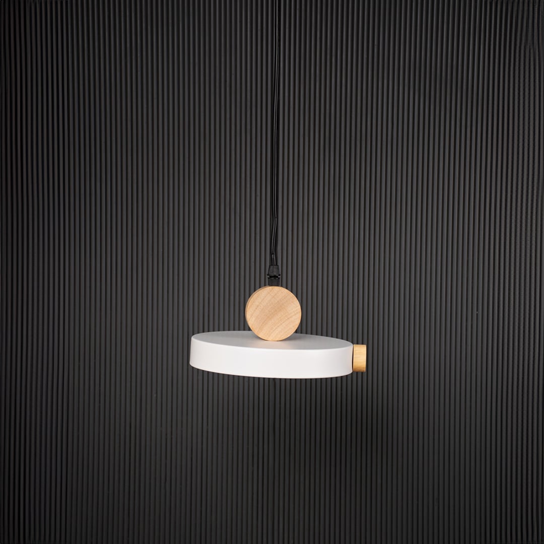 Modern pendant light with flat round shade and wood detail bulb off on black background for stylish home interiors.