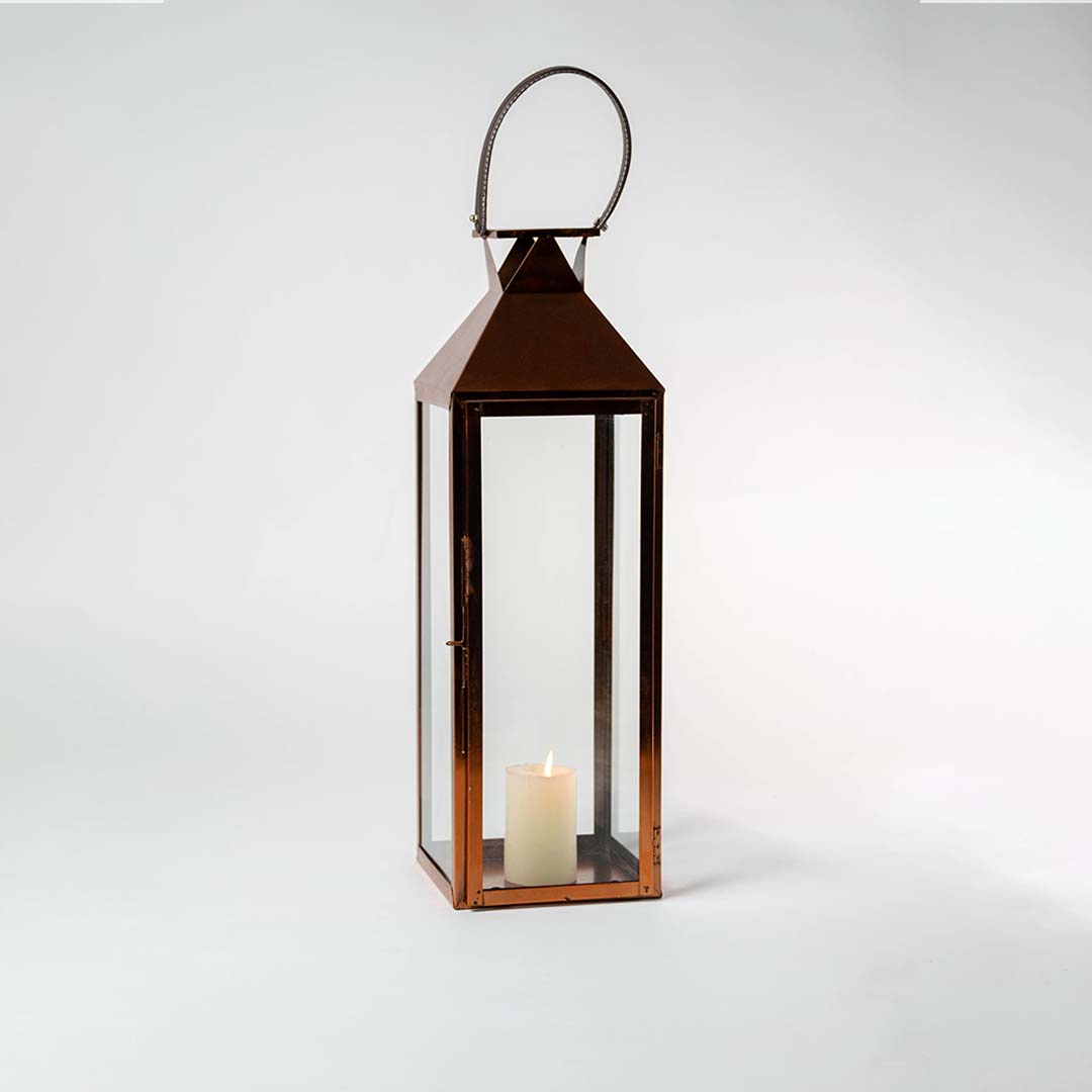 Tall brown metal lantern with openable glass door on white background ideal for candles and decorative interior styling.