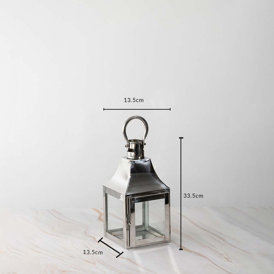 Stainless steel lantern dimensions 33.5cm height and 13.5cm width with polished finish and glass sides.