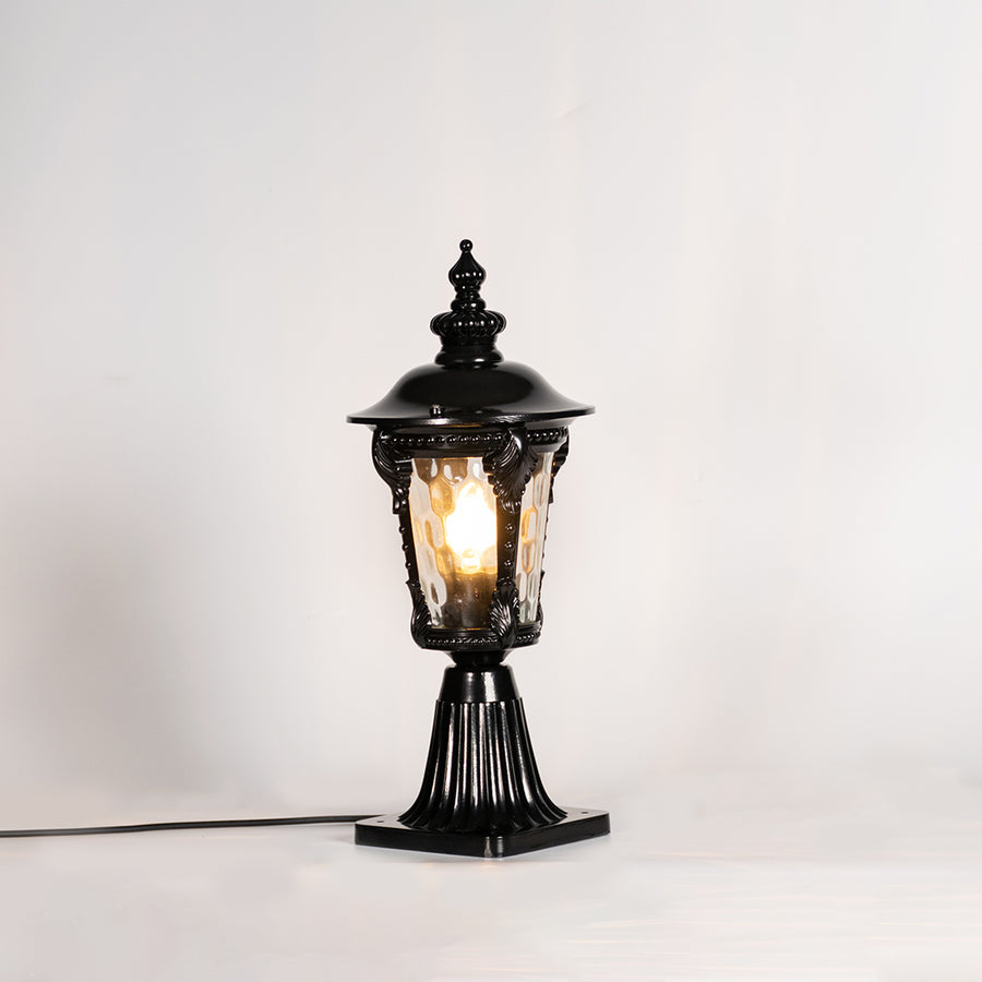 Vintage black outdoor gate light with warm glowing bulb for elegant exterior decor styling use.