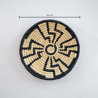 Circular woven wall basket with zigzag black and natural pattern displaying approx 30 cm diameter for interior wall styling.