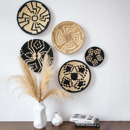 Handcrafted woven wall basket displayed above console table with vases and books – bohemian home wall decor accent.