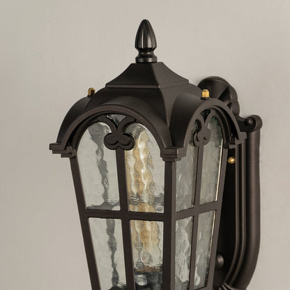 Black metal outdoor wall light closeup image showing premium water glass texture and intricate arch detailing for decor.