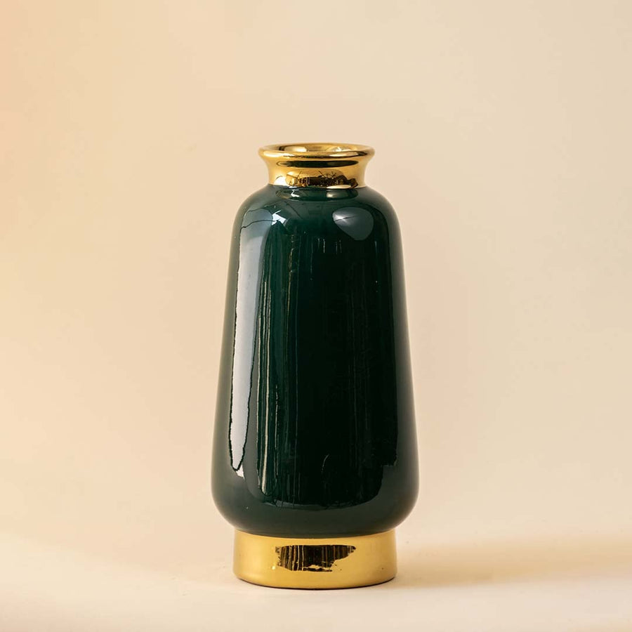 Green ceramic vase with shiny finish and gold detailing displayed on a clean white background highlighting its smooth modern design.
