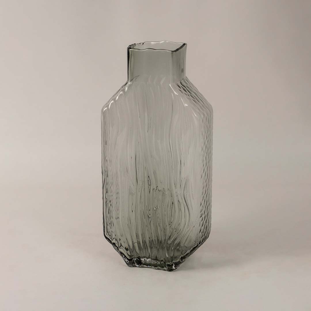 Side view of tall smoky gray glass vase showcasing its elegant textured pattern and refined modern form.