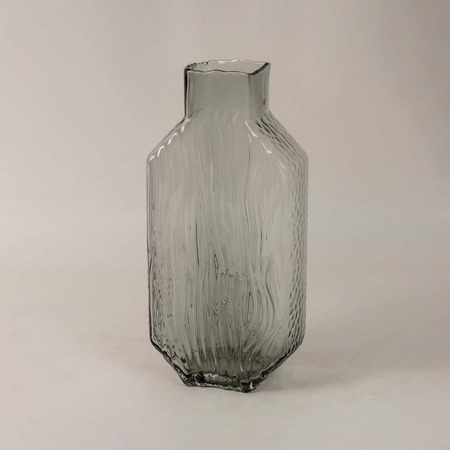 Side view of tall smoky gray glass vase showcasing its elegant textured pattern and refined modern form.