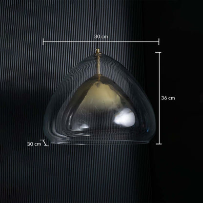 Glass pendant light with transparent curved shade and gold interior displayed against a dark striped background showing dimensions of 30 cm width 36 cm height and 30 cm depth.