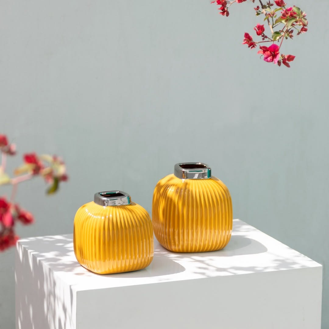 Yellow ceramic ribbed mini vase styled in a soft neutral scene adding a bright modern touch to tabletop home decor.
