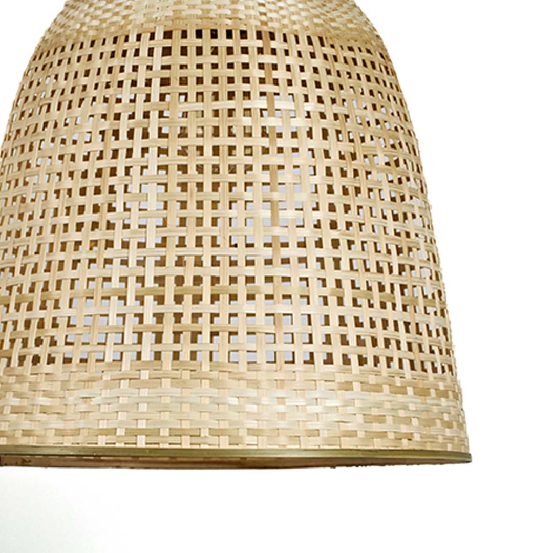 Closeup of tall rattan pendant light with handwoven bamboo shade in natural finish for modern interiors.