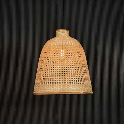 Handwoven rattan pendant light with tall bamboo shade turned on glowing softly against black background.