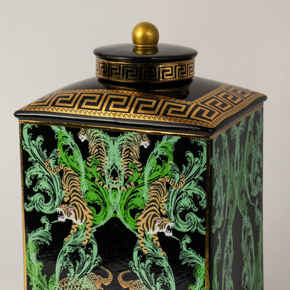 Closeup of black ceramic jar showing artistic tiger details and glossy gold-trimmed lid.