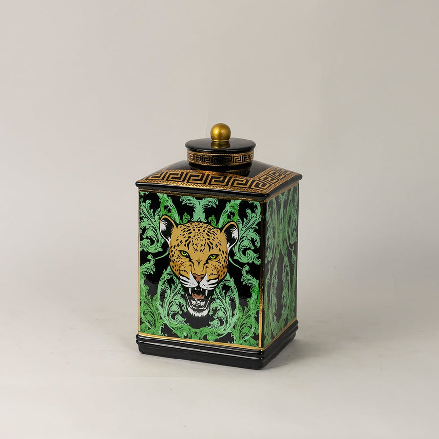 Side angle view of black ceramic jar showing elegant golden top and bold leopard-themed artwork.